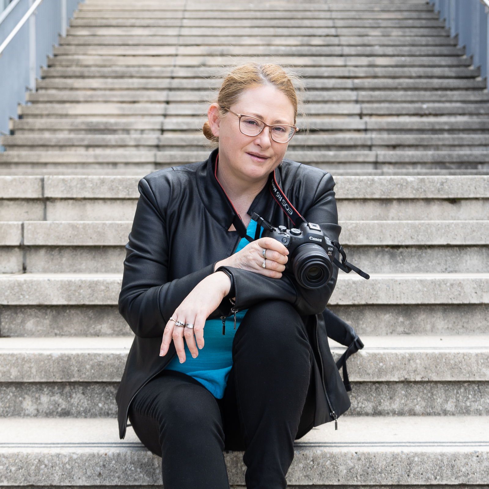 Photographer with camera sitting on steps