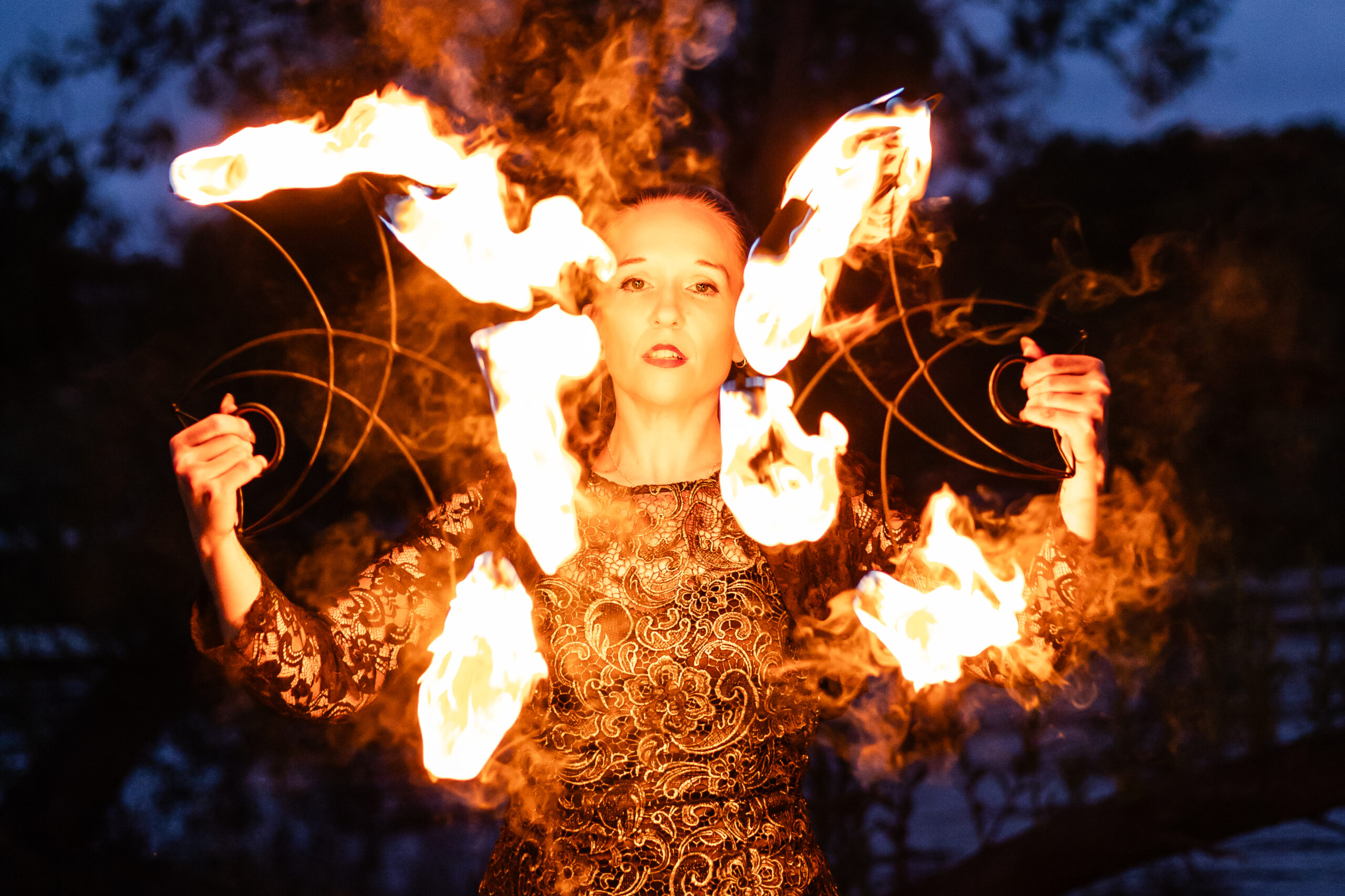 Woman with face illuminated by flames