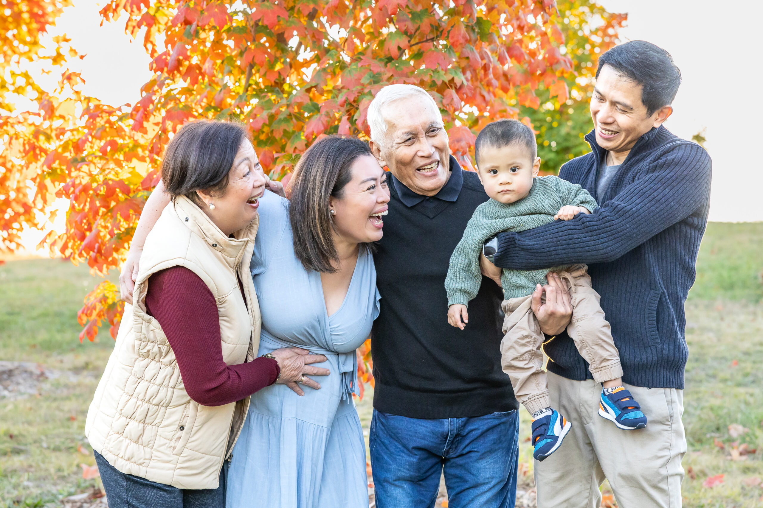 Extended family with autumn leaves in background at National Arboretum in Canberra